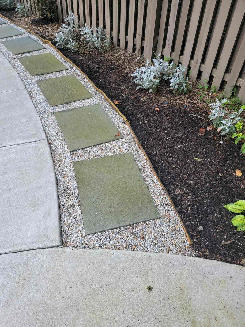 Amazon customer review mentioning Shabebe Rock Glue winning over a skeptical buyer, drying within hours and holding gravel firm after a 50/50 water mix sprayed on with a garden sprayer.