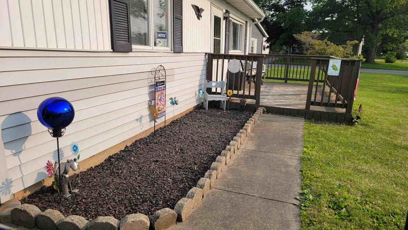 Amazon customer review praising Shabebe Mulch Glue for securely holding rubber mulch in all weather conditions.
