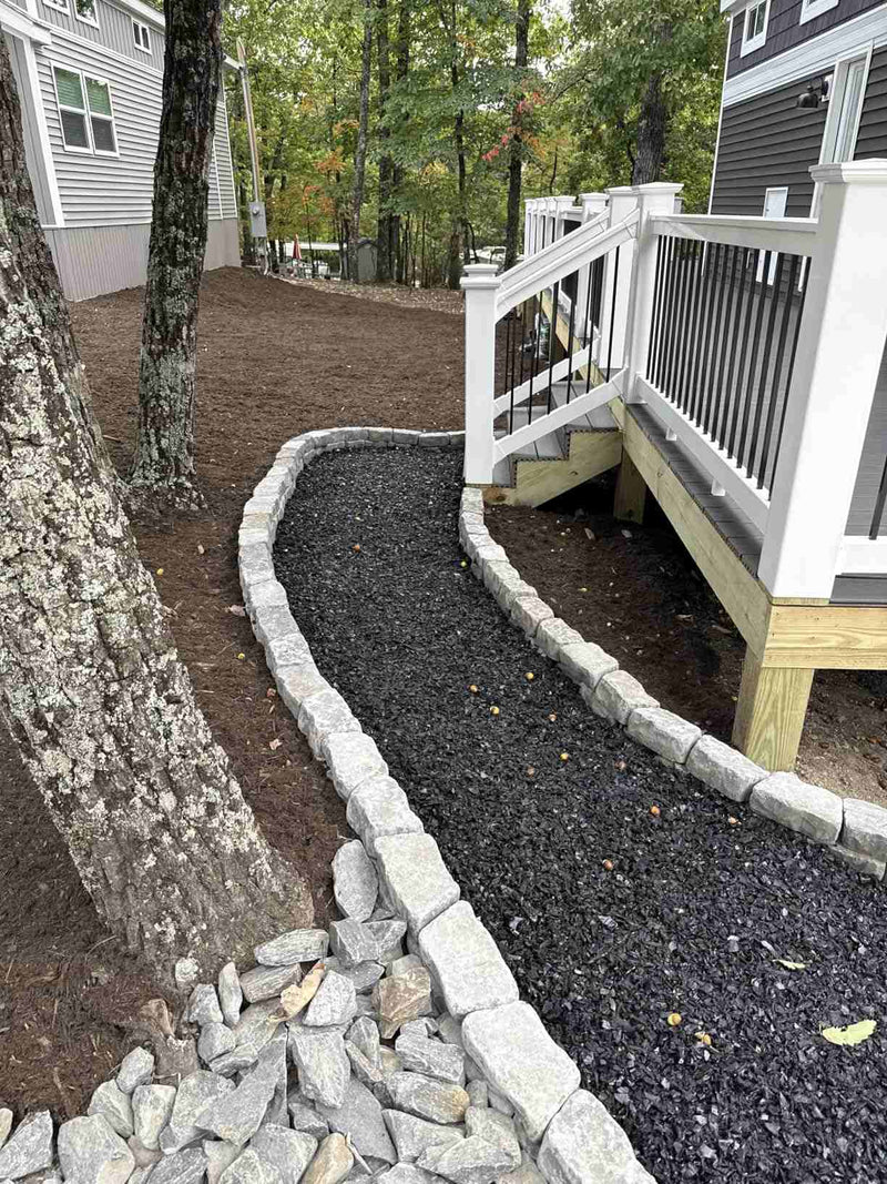 Amazon customer review praising Shabebe Mulch Glue for keeping rubber mulch in place against wind and leaf blowers, still holding strong after 1 month.