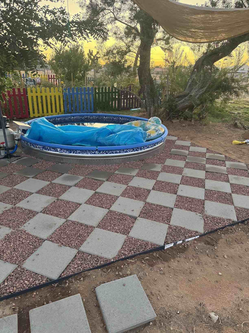 Amazon customer review mentioning Shabebe Rock Glue keeping decorative rocks locked in place while letting water drain through, used around a checkered patio.